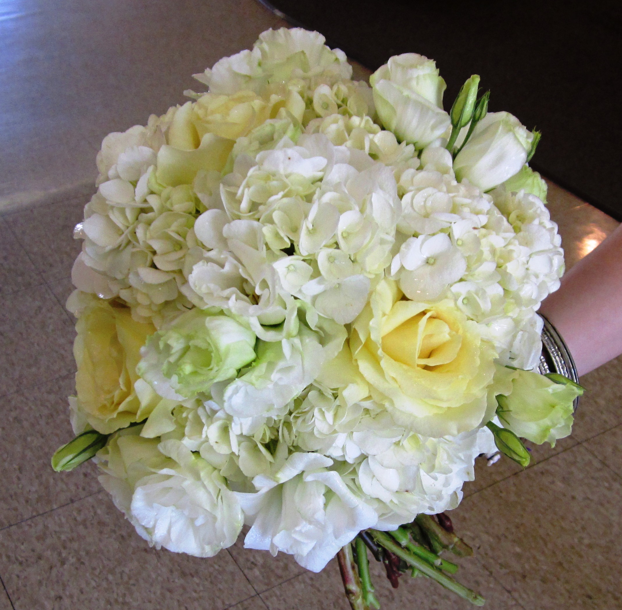 White roses, white hydrangea, Cream garden roses and lisianthus in a 